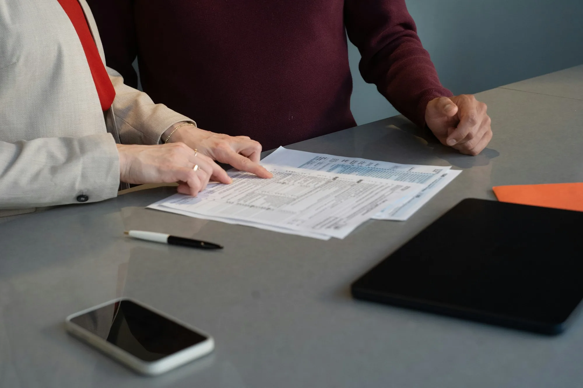 Two people reviewing paperwork together at a table